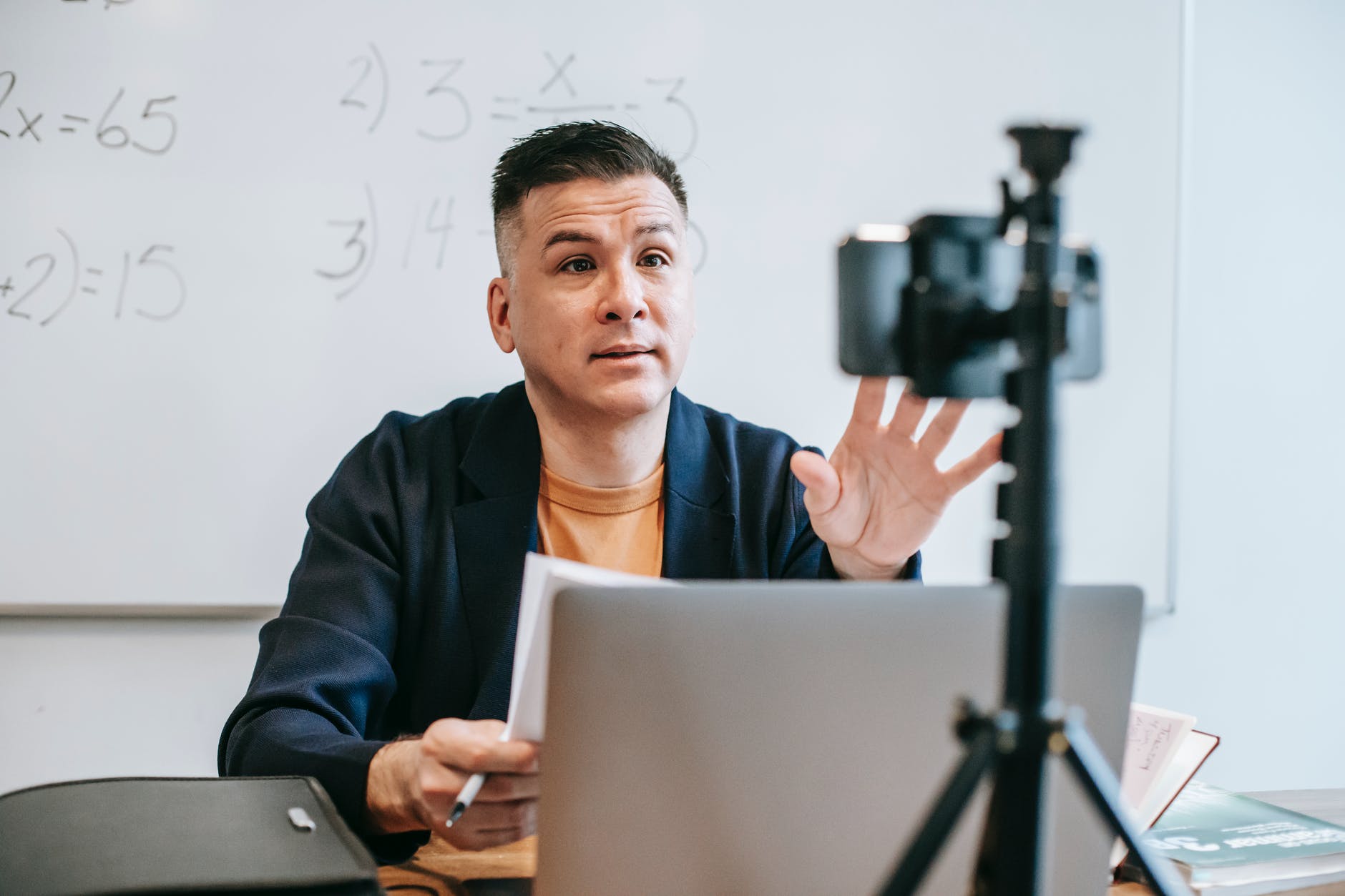 photo of man teaching via smartphone