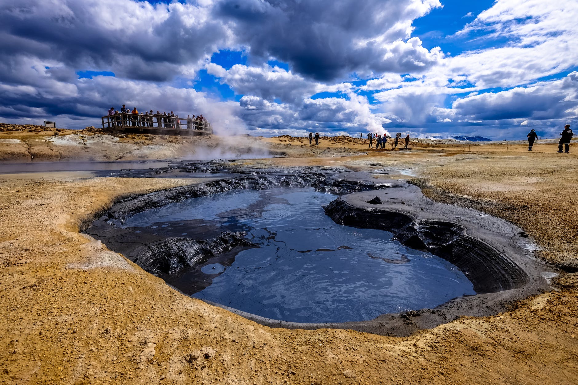 group of people gather near hot spring