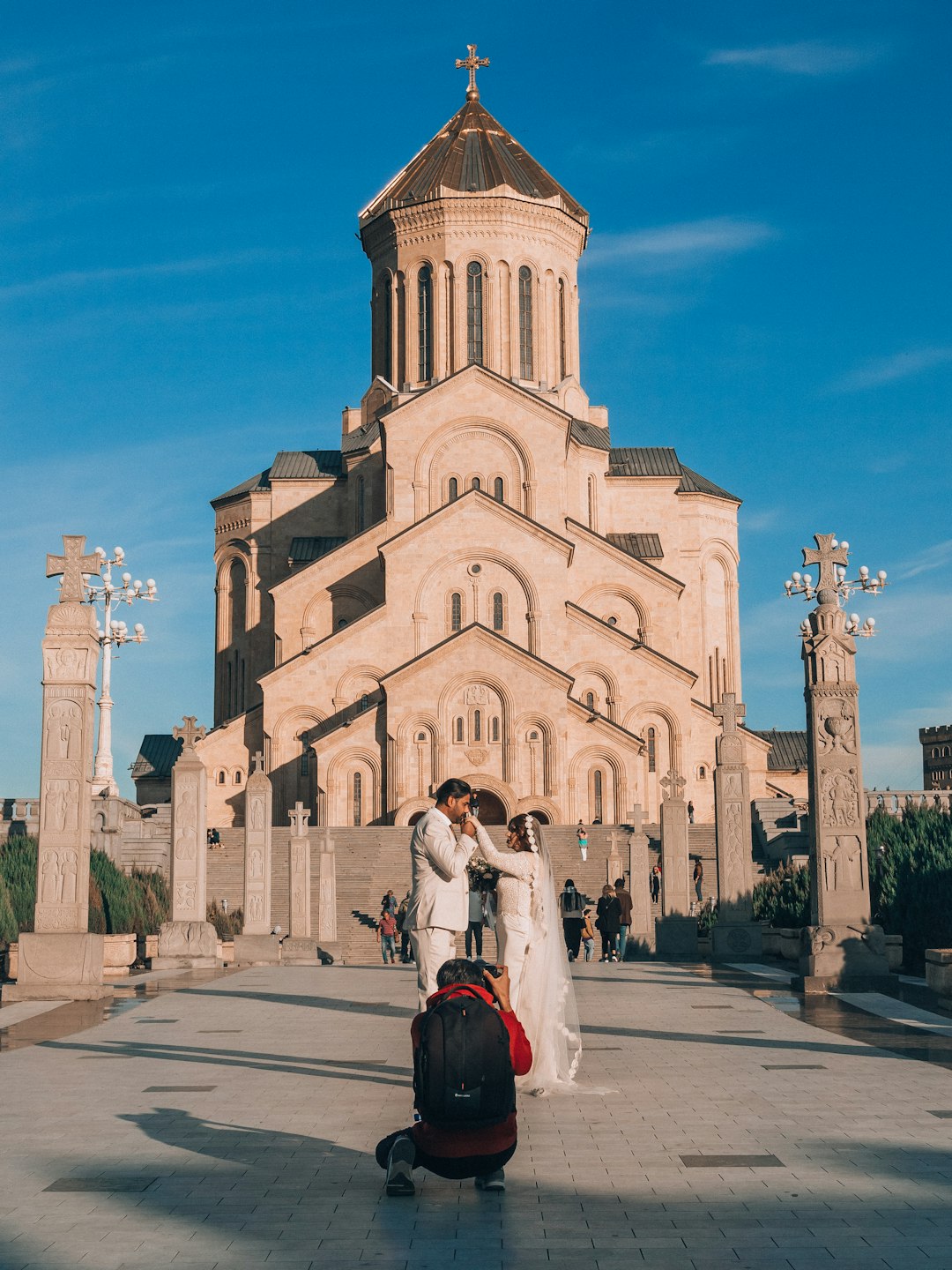 A man and woman standing in front of a church