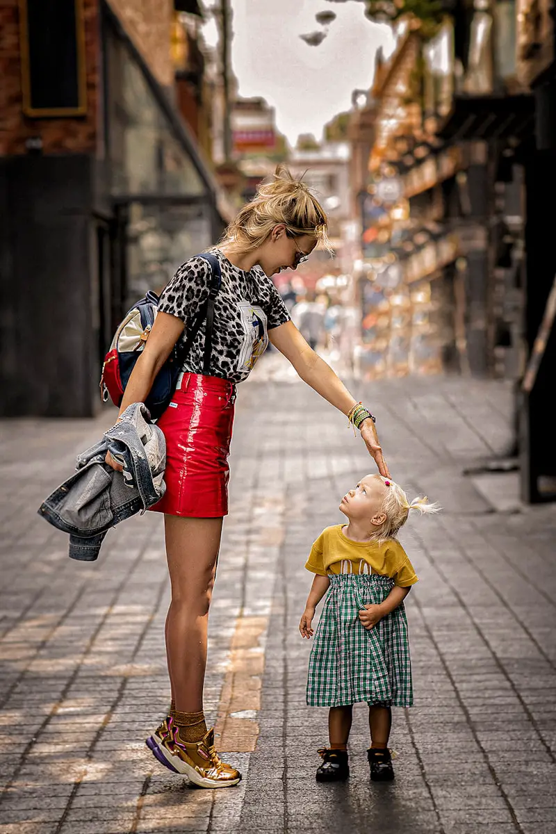 a woman and a child walking on a sidewalk