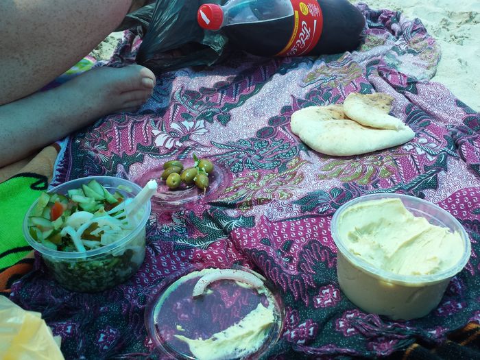 Picnic setup on Dor-Habonim Beach with Mediterranean coastline